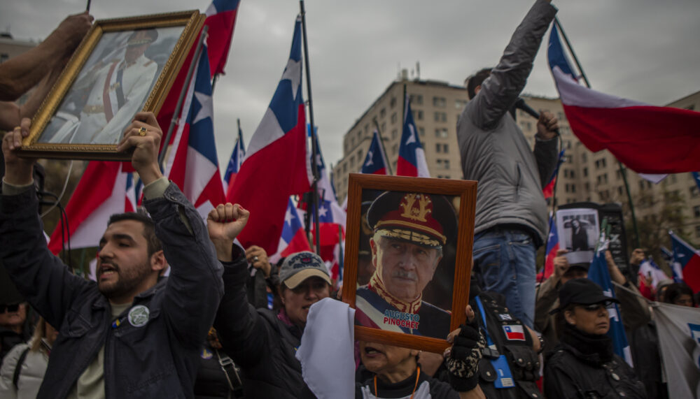 Far-right groups gather in front of La Moneda presidential palace on 9 September 2023 in Santiago de Chile to celebrate the 1973 coup d'etat